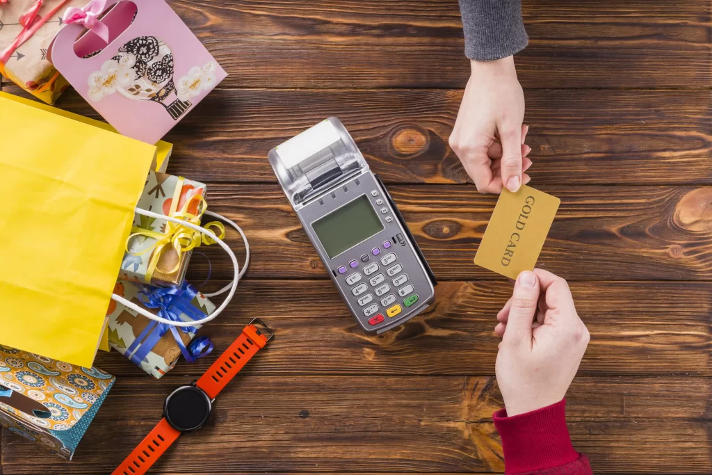 shopkeeper and customer exchanging credit card over the counter